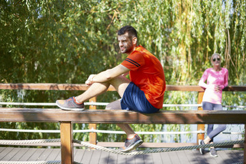 Running is my daily routine. Full length shot of a young jogger stretching in the morning outside in the park.