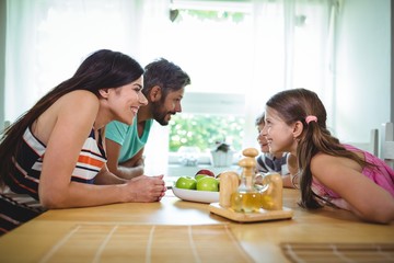 Wall Mural - Parents and kids looking face to face and smiling