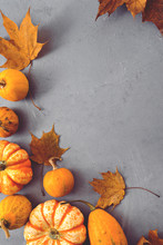 Small Orange Pumpkins  With Leaves On Table