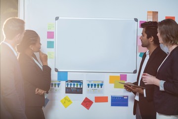 Canvas Print - Group of businesspeople looking at whiteboard