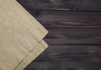 Wall Mural - Dark wooden table with tablecloth, top view