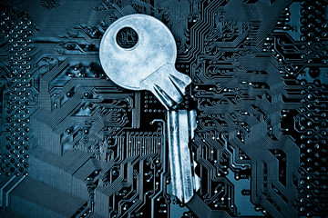 a broken key on computer circuitboard background / computer security breach concept