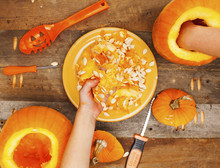 Close-up Kids Hands Carving Halloween Pumpkins