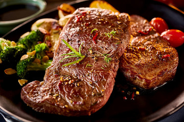 Close up on pair of grilled beef with vegetables