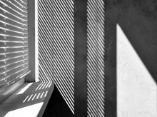 Geometric Black And White Composition. The Plane Of The Plaster Wall With A Structural Graphic Shadow Falling From The Blinds. Horizontal View.