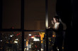 © Dusan Petkovic - Young designer working on laptop at night near window with beautiful view.