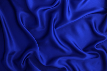 close up wave luxury blue silk or satin fabric background