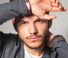 Wall Mural - young man with hand on forehead and neck