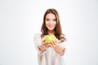 © Drobot Dean - Smiling young woman giving apple at camera