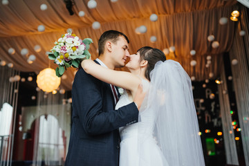 Bride and groom at wedding Day. Wedding photo session in interior. Bridal couple, Happy Newlywed woman and man embracing. Romantic wedding.