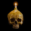 © Satit _Srihin - skull with candle light on top with clipping path on black backg
