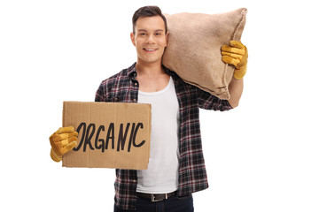 Canvas Print - Agricultural worker with cardboard sign and sack