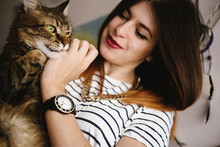 Stylish Hipster Woman Playing With Her Cat In Modern Room