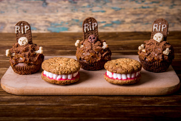 Wall Mural - Dentures for Halloween made of cookies and marshmallow and Halloween cupcakes with tombstone