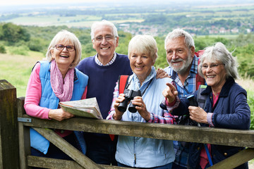 Group Of Senior Friends Hiking In Countryside