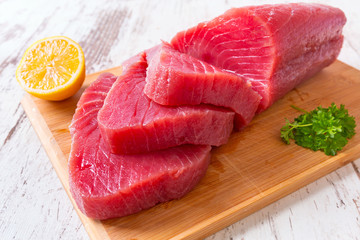 Raw tuna steak on wooden cutboard