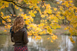 © Goncharenya Tanya - Beautiful girl blonde with wavy hair standing near the autumn tree with yellow leaves with his back to the viewer
