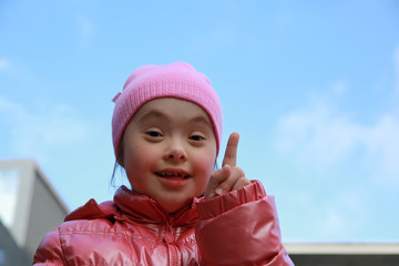 Portrait of beautiful girl on background of the blue sky