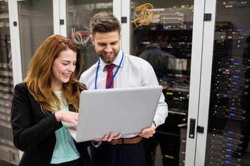 Wall Mural - Technicians using laptop while analyzing server