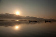 © ivanmateev - Intha fisherman fishing at sunset in his typical canoe with fish