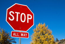 Stop Sign With Changing Colors Of Autumn Trees