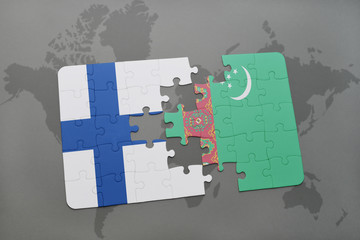 puzzle with the national flag of finland and turkmenistan on a world map background.