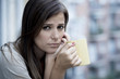 © Wordley Calvo Stock - young sad beautiful woman suffering depression looking worried and wasted on home balcony