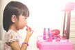 Leinwandbild Motiv Asian Chinese Liitle Girl Playing With Make-Up Toys