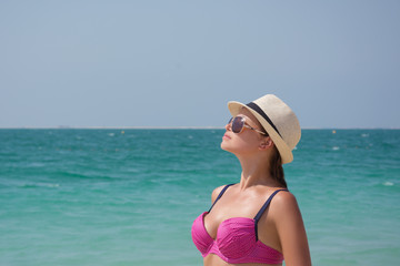 Young slim girl in a bathing suit on the beach, Dubai