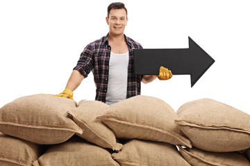 Poster - Farmer behind pile of burlap sacks with an arrow