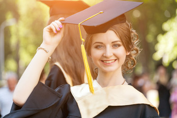 Graduate students wearing graduation hat and gown