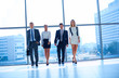© lenets_tan - Young businesspeople standing in modern office lobby.
