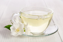 Glass Cup Of Tea With Jasmine On The White Wooden Background