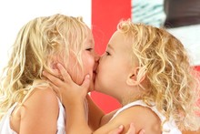 Cute Little Girls Kissing Each Other At Home