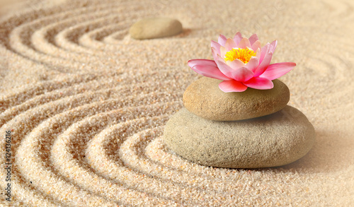 Fototapeta na wymiar Sand, flower lily and spa stones in zen garden