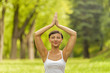 © Wisiel - Woman meditating and doing yoga in park