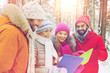 © Syda Productions - smiling friends with tablet pc in winter forest