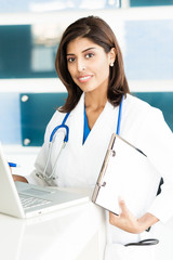 Wall Mural - Young Woman Hispanic Doctor Nurse in Medical Office