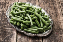 Bunch Of Freshly Picked Green Beans On A Wooden Surface.