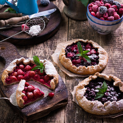 Blueberry,cherry,raspberry and blackcurrant galette on w wooden background.