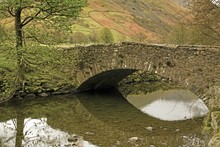 Cumbria, England; A Cow Bridge Over Brothers Water In Lake District National Park