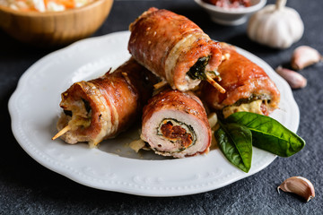 Sticker - Pork cutlets wrapped in bacon and stuffed with cheese, spinach and sun dried tomato