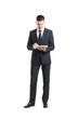 © Acronym - Young businessman with a tablet computer on white