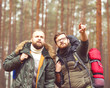 © Acronym - Men with backpacks and beards hiking in the forest