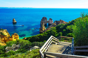 Wall Mural - Wooden walkway to beautiful beach Praia do Camilo, Portugal