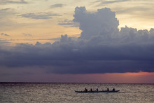 Outrigger Canoe In The Ocean At Sunset