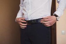 Closeup Of Caucasian Man Putting On His Belt