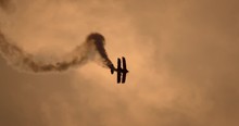 Retro Plane Smokes Barrel Roll In The Sky