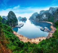 Tourist Junks Floating Among Limestone Rocks At Ha Long Bay, South China Sea, Vietnam, Southeast Asia