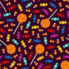 Halloween seamless pattern with small sweets on dark background. Holiday trick or treat concept.